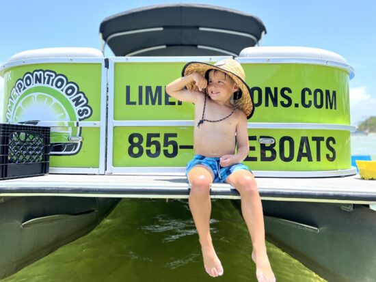 child playing on boat - lime pontoon rentals