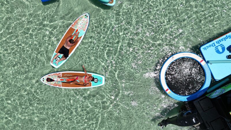 friends on crab island destin with paddle boards floating dock lillypad and pontoon boat