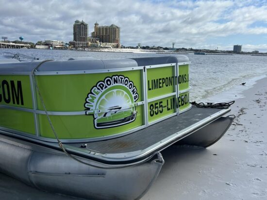 scenic beach along the destin harbor with pontoon boat