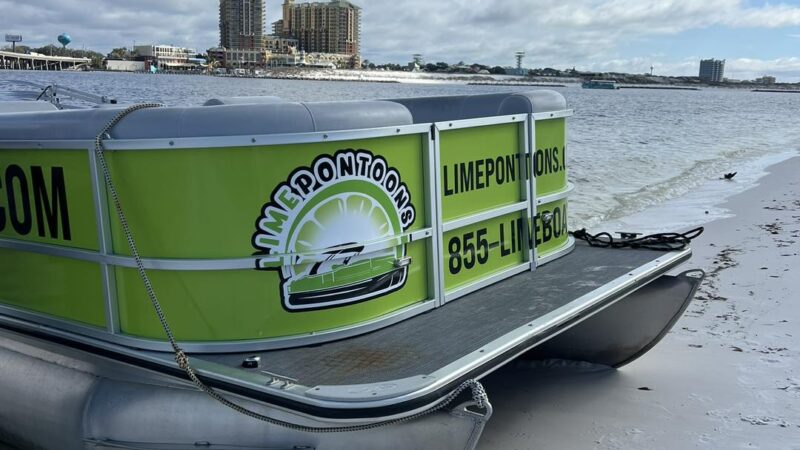 scenic beach along the destin harbor with pontoon boat